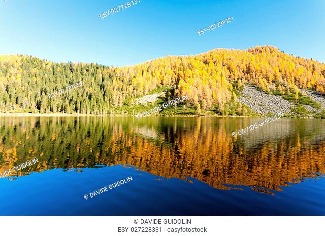 Mountain panorama from Italian Alps. Reflections on water from ""Calaita"" lake. Beautiful dolomites