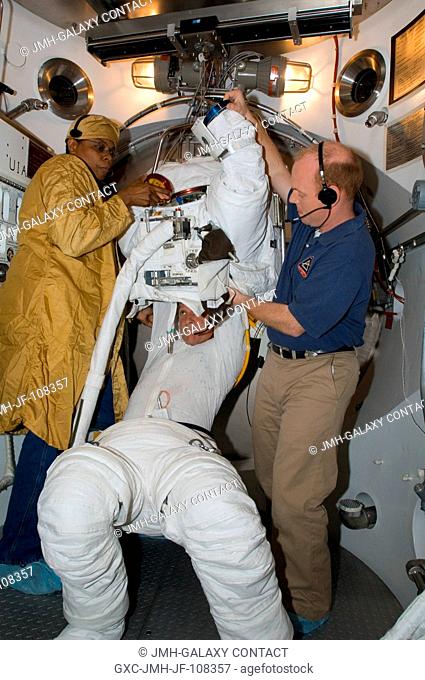 Astronaut Scott E. Parazynski, STS-120 mission specialist, participates in an Extravehicular Mobility Unit (EMU) spacesuit fit check in the Space Station...