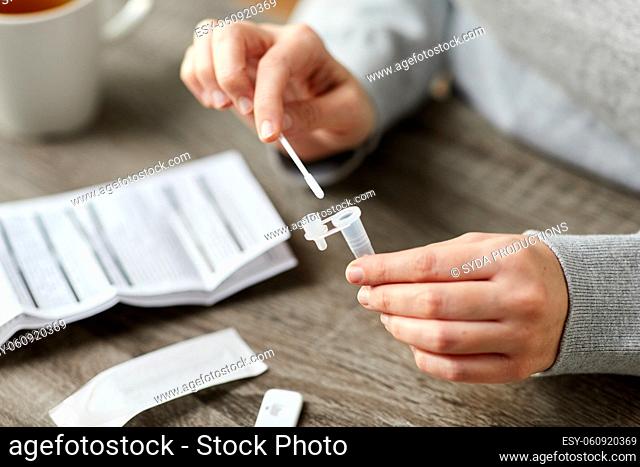 woman making self testing coronavirus test at home