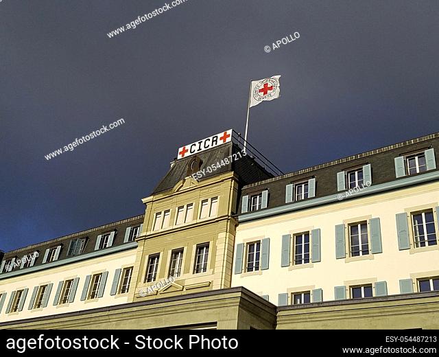 Dark storm clouds approaching the headquarters of the International Committee of the Red Cross, ICRC, with the Red Cross flag, Geneva, Switzerland