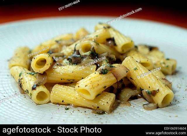 A dish of rigatoni with late red radicchio sauce