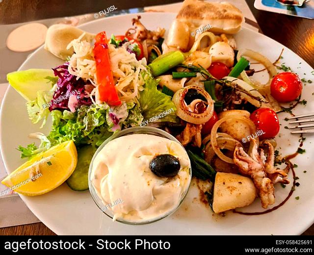 Grilled squid, street food. stuffed squid. salat