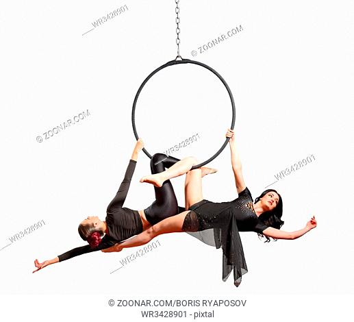 Young women doing gymnastic exercises on the hoop