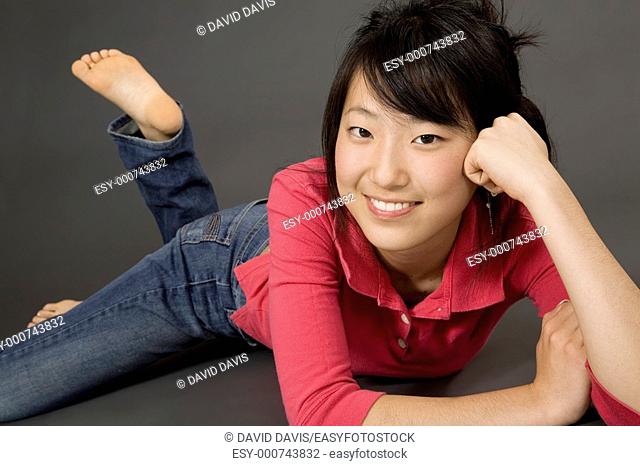 Asian Teenage girl posing on gray background with some attitude