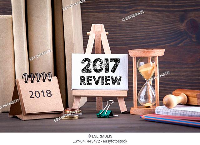 2017 review. Sandglass, hourglass or egg timer on wooden table showing the last second or last minute or time out