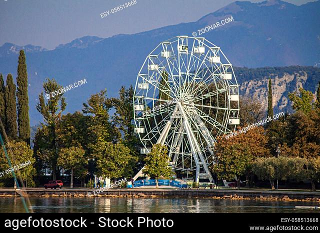 Panorama of Garda Lake in Bardolino with Ferris wheel during summer