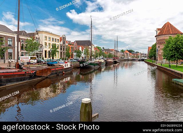 Zwolle, The Netherlands - May 30 2014: Cityscape Dutch medieval city Zwolle with canal and old moored sailing ships
