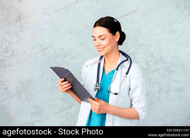 Young female doctor with stethoscope and folder. caucasian brunette