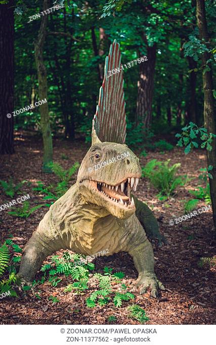 Solec Kujawski, Poland - August 2017 : Life sized spinosaurus dinosaur statue in a forest