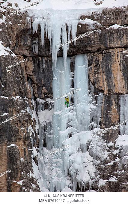 Waterfall ice climbing in winter in Langental, Val Gardena, Dolomites, Italy