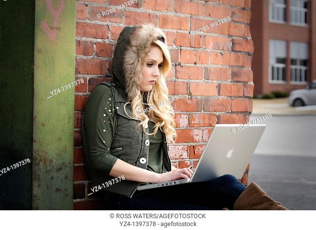 Female student with a laptop studying