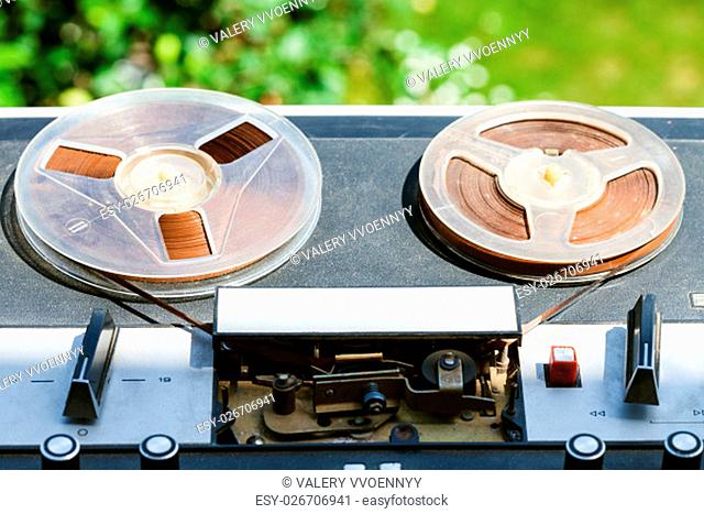 old reel-to-reel recorder with in reels outdoors