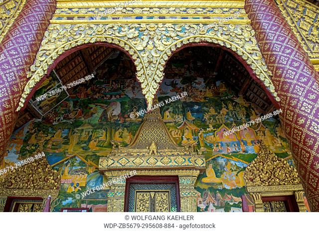 Detail with frescoes and door of Wat Xieng Muan (Xieng Muan Vajiramangalaram) a Buddhist temple in the UNESCO world heritage town of Luang Prabang in Central...