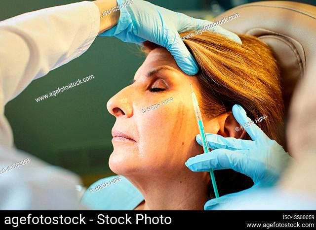 Close-up of woman receiving botox injection