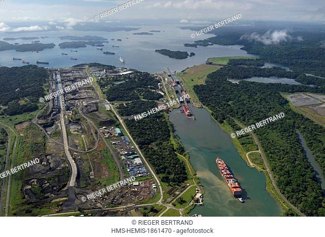 Panama, Colon province, Panama Canal, Panamax cargo passing the Gatun locks, the construction of the new locks on the left and the Gatun Lake in the background...