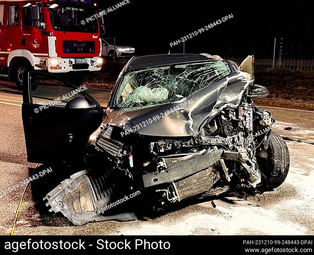 10 December 2023, Bavaria, Pleinfeld: A car is left on the road after an accident. A young female driver was critically injured in a head-on collision in Middle...