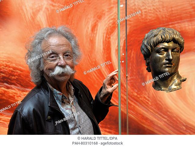 Science journalist and television host Jean Puetz stands in front of the bronze bust of Nero, on loan from the Louvre in Paris, in the Landesmuseum in Trier