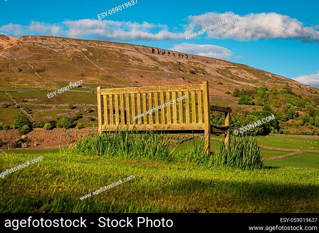 A bench overlooking the Arkengarthdale landscape near Reeth, North Yorkshire, England, UK