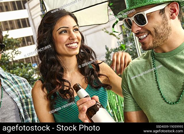 Man and woman dancing and having fun while at St Patrick's Day party outside