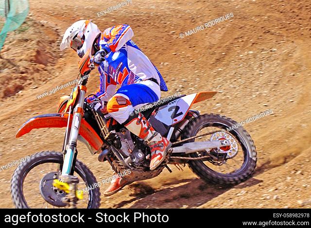 Motorcycle driver sliding on the dirt track