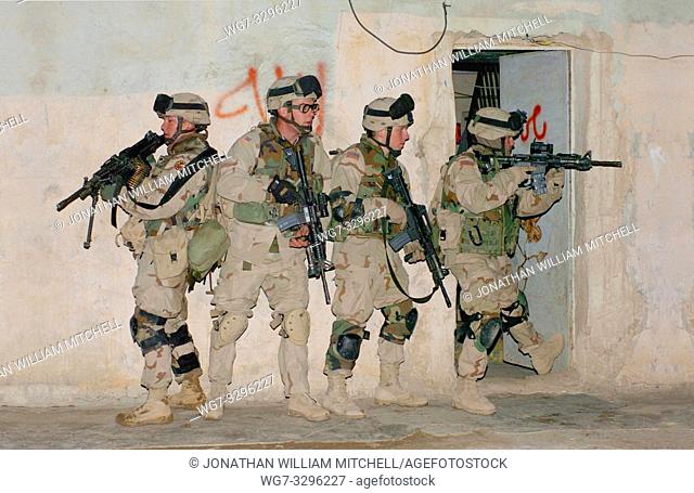 IRAQ Siniyah -- 14 Jan 2005 -- US Soldiers from the Pennsylvania National Guard's Alpha Company, 1st Battalion, 111th Infantry Regiment prepares to raid a home...