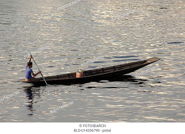 Boy rowing on Inle Lake