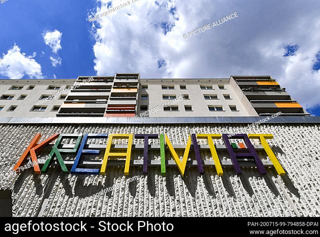 14 July 2020, Berlin: The word creativity is attached to a residential building in Hohenschönhausen at Prerower Platz. It belongs to the Kunsthaus 360 Grad