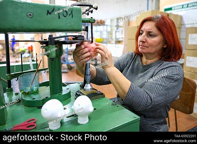 RUSSIA, VORONEZH - DECEMBER 19, 2023: Sewing hair to dolls at the Igrushki toy factory. The enterprise is engaged in production of PVC plastisol toys