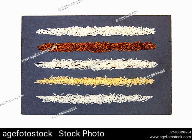 Rice collection on slate plate. Different kinds of rice on the slate desk