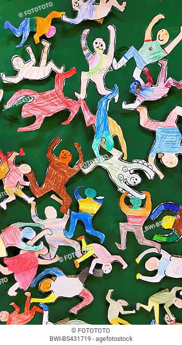 cut out and painted cheering children in front of green background