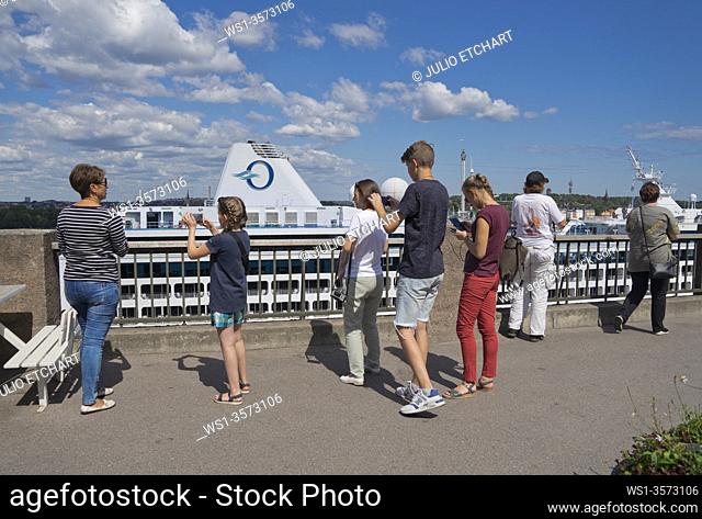 Passengers from a cruise liner visiting a neighbourhood in Stockholm, Sweden.