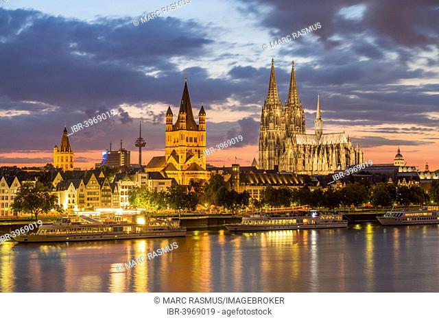Historic centre with Cathedral, Great St. Martin Church, Colonius, WDR building and City Hall, the Rhine at the front, dusk, Cologne, North Rhine-Westphalia