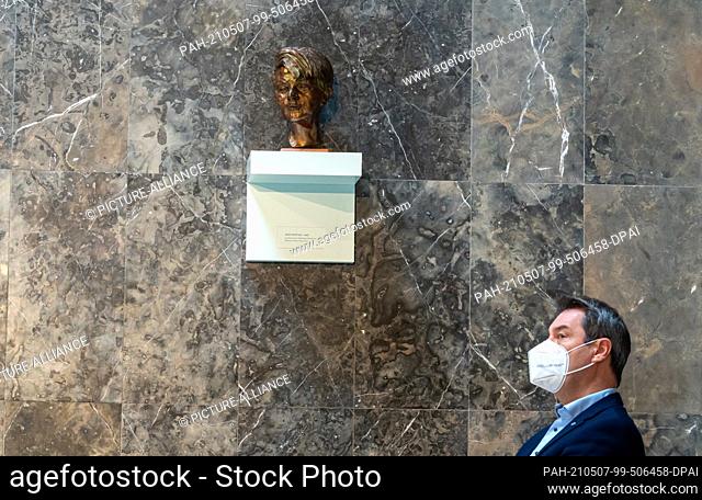 07 May 2021, Bavaria, Munich: Markus Söder (CSU), Prime Minister of Bavaria, sits under a bust of Sophie Scholl during a memorial service in her honor