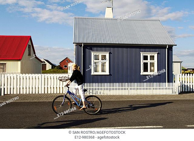 Iceland, Eyrarbakki village old houses, kids playing in the street with bicycle