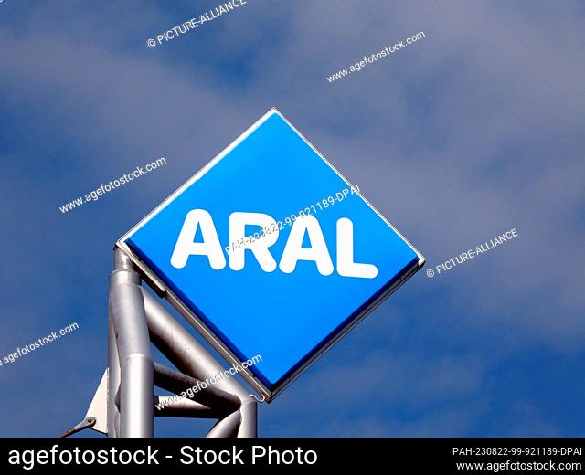 20 August 2023, North Rhine-Westphalia, Cologne: Logo, lettering of Aral AG on a gas station in front of blue sky a mineral oil company of BP group in Germany