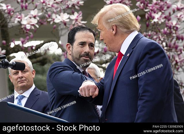 United States President Donald J. Trump, right, bumps elbows with Bruce Greenstein, Executive Vice President and Chief Strategy and Innovation Officer at LHC...