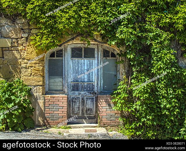 front door with peeling paint, Montignac Lascaux, Dordogne Department, Nouvelle Aquitaine, France
