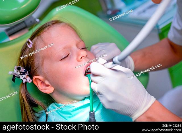 Healthy teeth patient girl at dentist office - dental caries prevention