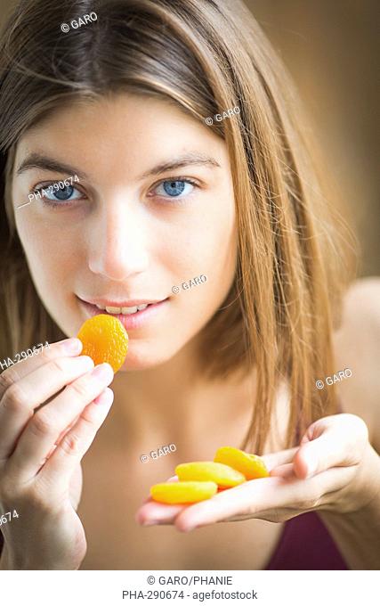 Woman eating dry apricot