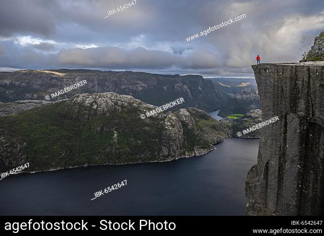 Individual on rock plateau, Preikestolen rock spire, Lysefjord, Ryfylke, Rogaland, Norway, Europe