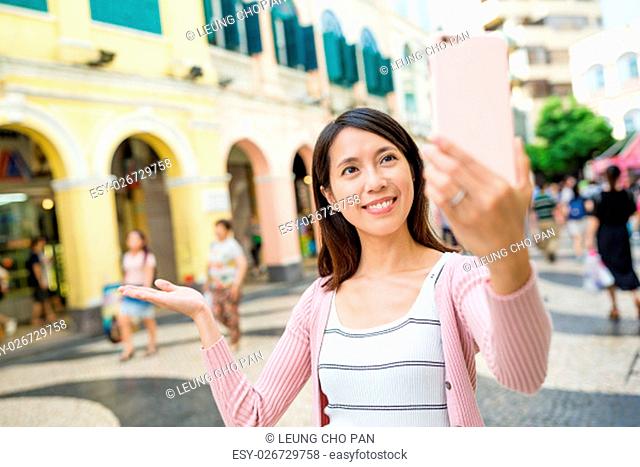 Woman taking self image by mobile phone in Macao city