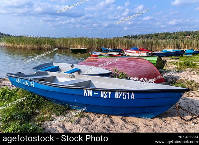 Boats on shore of Narie Lake located in Ilawa Lakeland region, view from Kretowiny village, Ostroda County, Warmia and Mazury province of Poland
