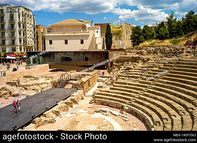 malaga, andalusia, spain: ancient ruins of roman theater (el teatro romano) at foot of famous alcazaba fortress. roman theater is oldest monument in malaga city