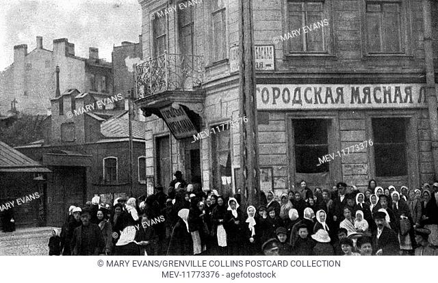 People in a Russian city queueing for food at a time when supplies were low, after the October Revolution of 1917