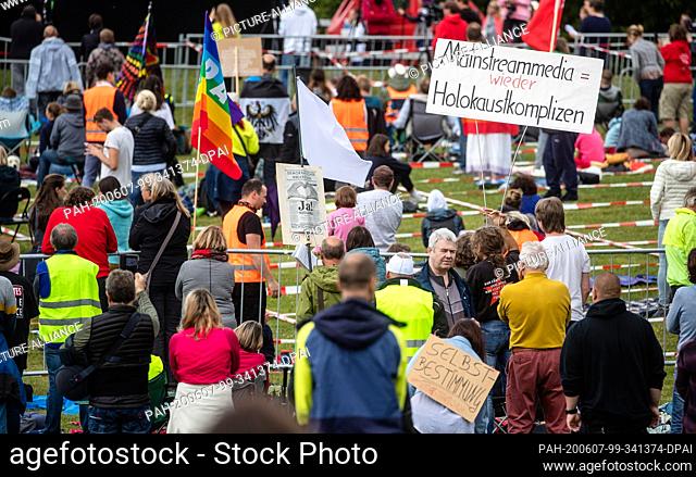 07 June 2020, Baden-Wuerttemberg, Leonberg: ""Mainstream media = Holocaust accomplices again"" is written on a sign of a participant of a demonstration of the...