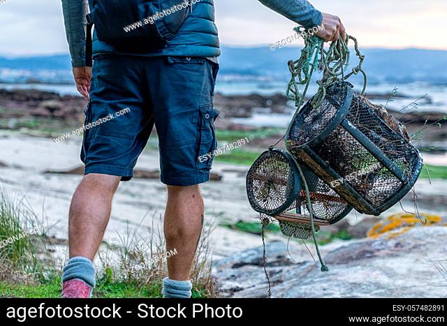 A detail view of fisherman with crab traps walking to the beach at low tide to go to work