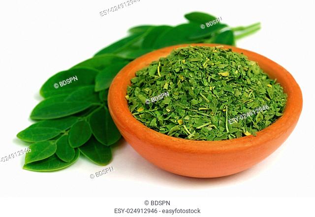 Green and dired moringa leaves with a small bowl