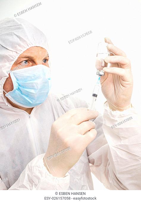 Man with syringe and vial in protective suit and mask