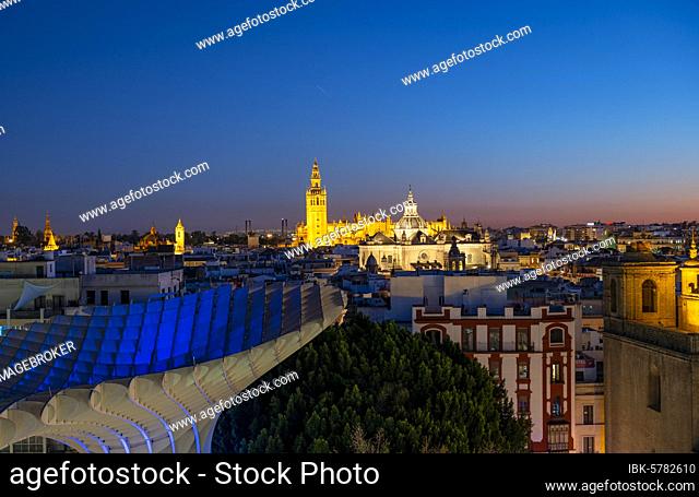 View from Metropol Parasol over the city, illuminated Cathedral of Seville with tower La Giralda, blue hour, Seville, Andalusia, Spain, Europe