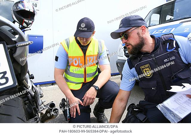 03 June 2018, Germany, Zwiefalten-Gauingen: Police officers check a motorbike during a control. Photo: Thomas Warnack/dpa